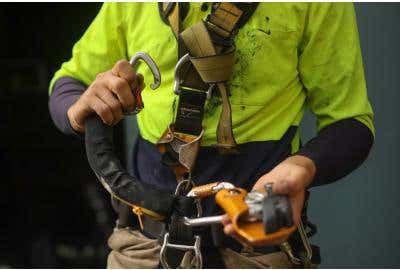 Construction Worker fastening harness.