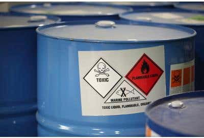 Container with labels which read "toxic," "flammable liquid," and "marine pollutant."