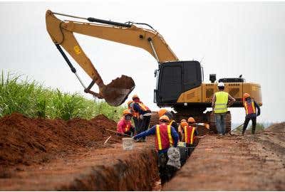 Construction workers in trench