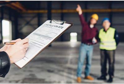 Inspector holding clipboard with form while two workers stand in the background