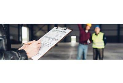 Inspector holding clipboard with form while two workers stand in the background