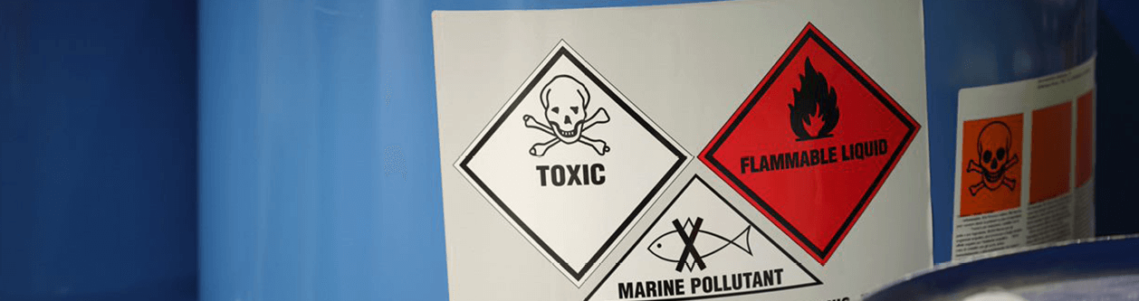 Container with labels which read "toxic," "flammable liquid," and "marine pollutant."