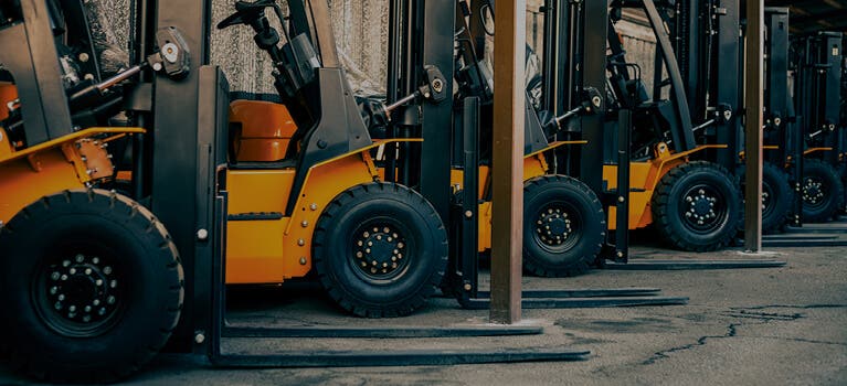 Trucks with forklifts in a warehouse