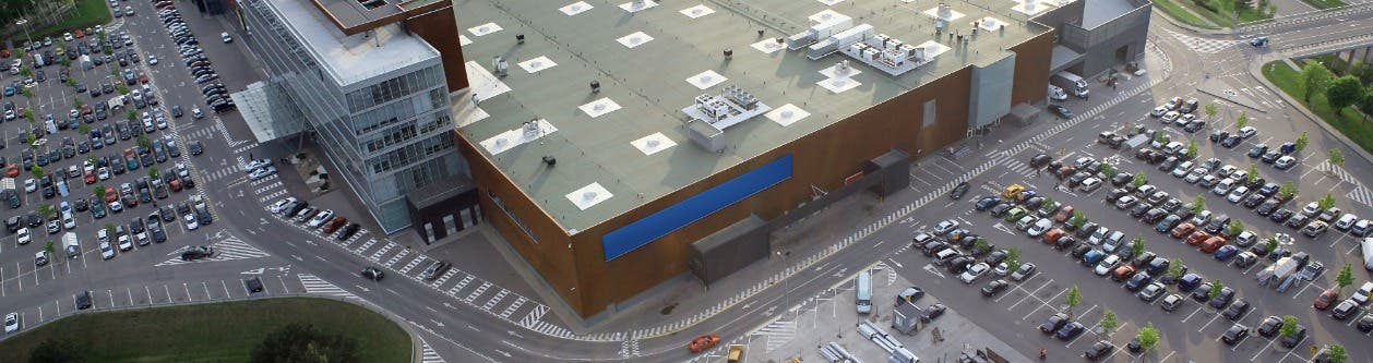 Worker on a roof with Fall Protection harness and other safety gear